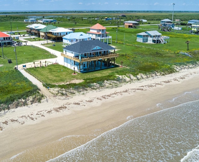 birds eye view of property featuring a view of the beach and a water view