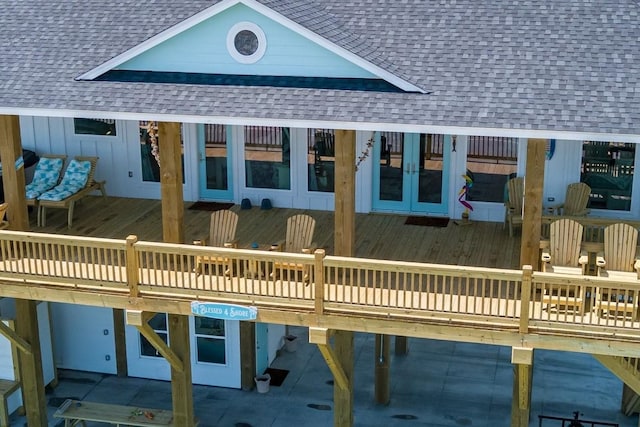 exterior space with a wooden deck and french doors