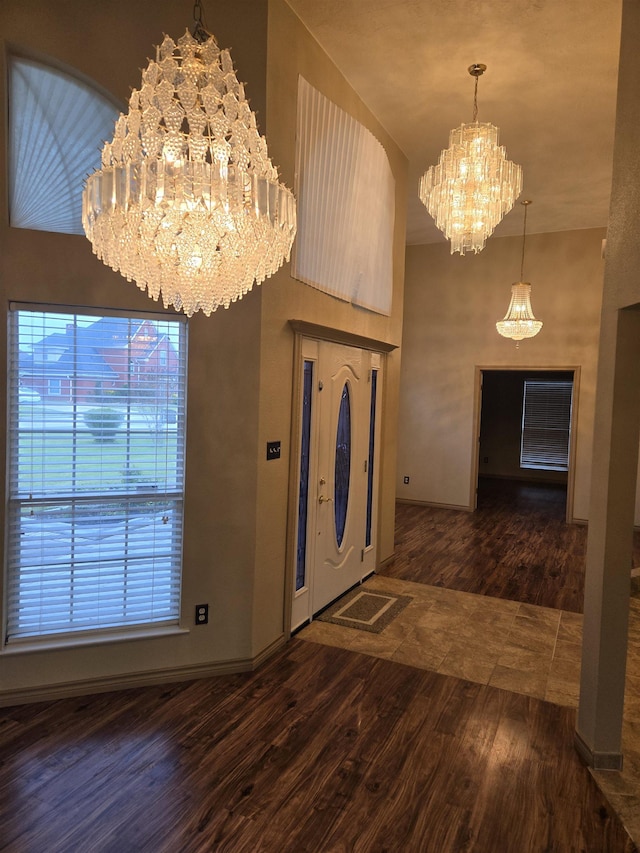 foyer entrance featuring an inviting chandelier and dark wood-type flooring