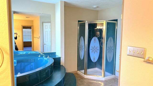 bathroom featuring shower with separate bathtub, a textured ceiling, and tile patterned floors