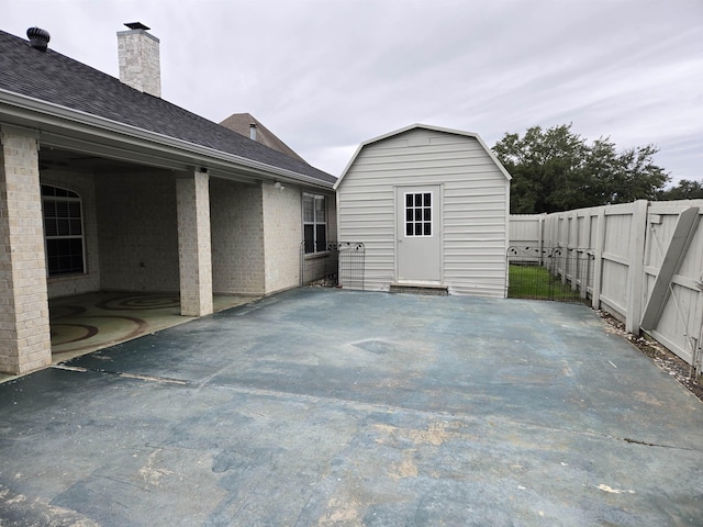 view of patio featuring a storage unit