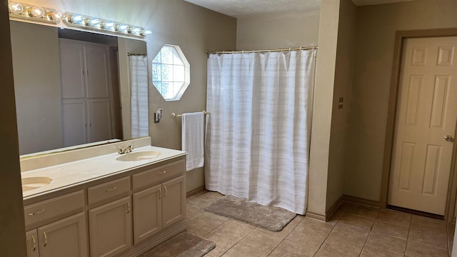 bathroom with tile patterned floors, a shower with curtain, and vanity