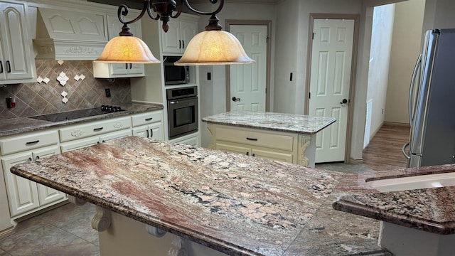 kitchen with a center island, premium range hood, dark stone counters, decorative backsplash, and stainless steel appliances