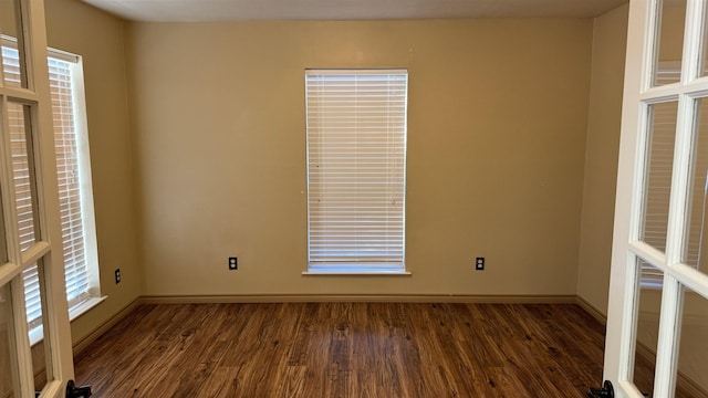 empty room with dark hardwood / wood-style flooring