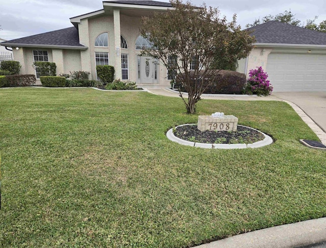 view of front of home with a front lawn and a garage