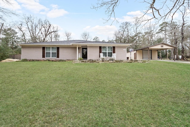 single story home featuring a carport, a front yard, concrete driveway, and brick siding