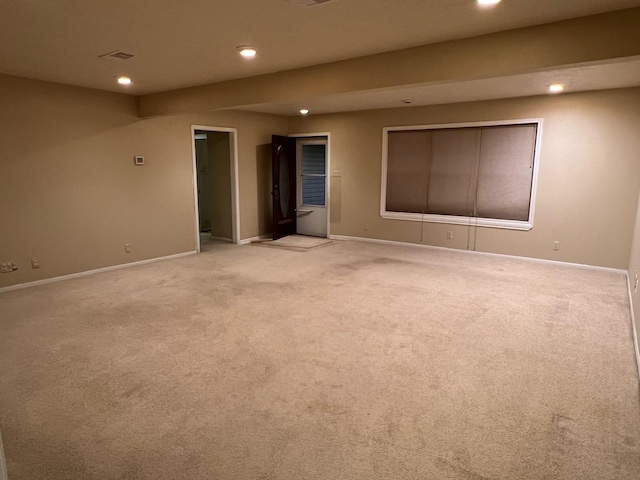 spare room featuring light colored carpet