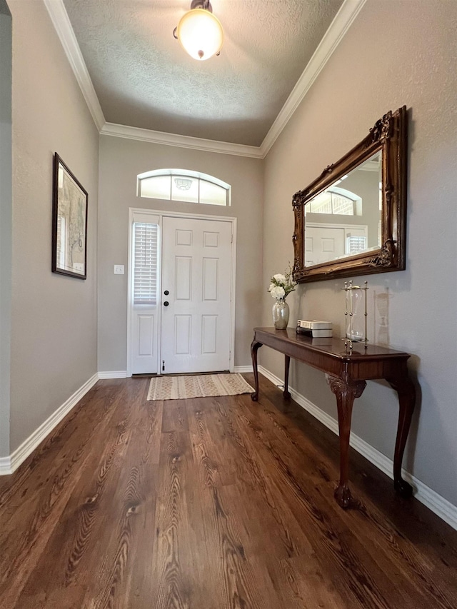 513 Harbor Oaks Dr, Beaumont, TX 77706 - entrance foyer featuring a textured ceiling, wood finished floors, ornamental molding, and baseboards