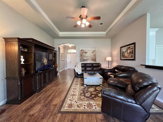 513 Harbor Oaks Dr, Beaumont, TX 77706 - living room with a tray ceiling, ceiling fan, arched walkways, wood finished floors, and baseboards