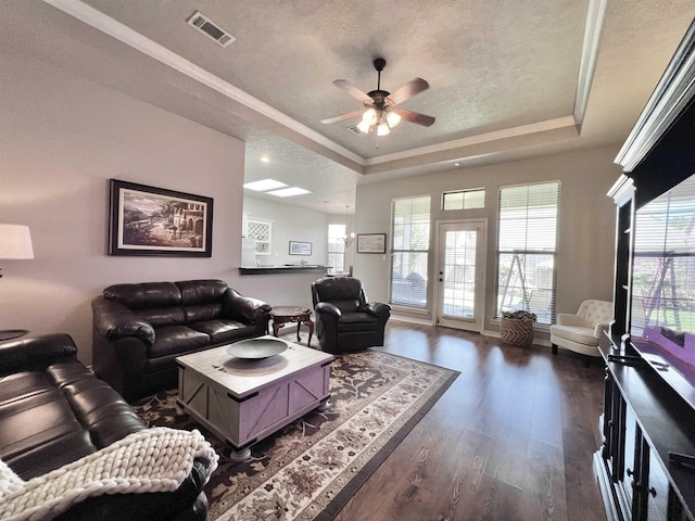 513 Harbor Oaks Dr, Beaumont, TX 77706 - living room featuring a raised ceiling, dark wood-style floors, ceiling fan, crown molding, and a textured ceiling