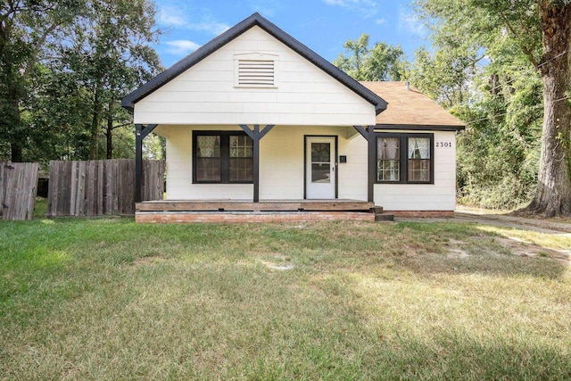 view of front of house with a porch and a front lawn