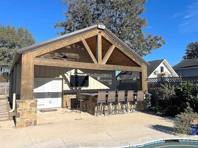 exterior space featuring ceiling fan and exterior bar