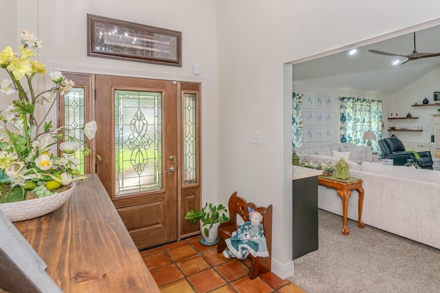 entrance foyer with light tile patterned floors, vaulted ceiling, ceiling fan, and a healthy amount of sunlight