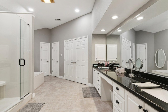 bathroom featuring vanity and independent shower and bath