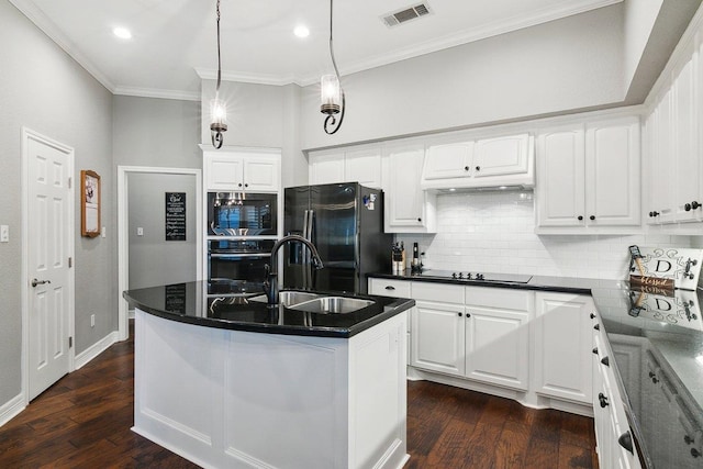 kitchen featuring oven, sink, a kitchen island with sink, stainless steel fridge with ice dispenser, and white cabinets