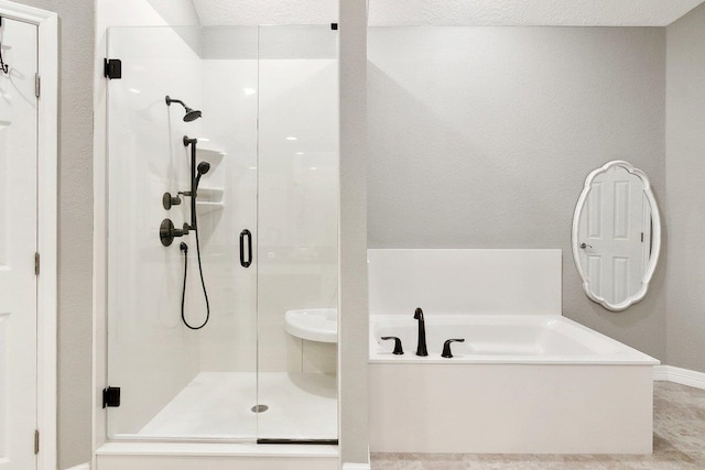 bathroom featuring separate shower and tub