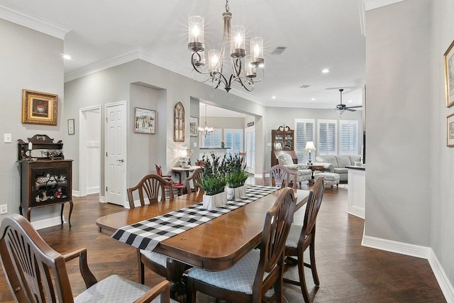 dining area featuring dark wood-type flooring, ceiling fan with notable chandelier, and ornamental molding