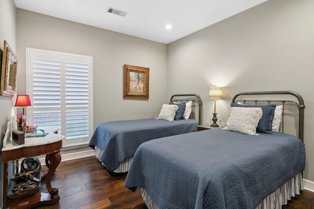 bedroom with dark hardwood / wood-style floors