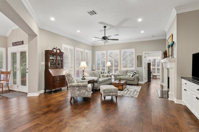 living room with ceiling fan, a healthy amount of sunlight, dark hardwood / wood-style flooring, and crown molding