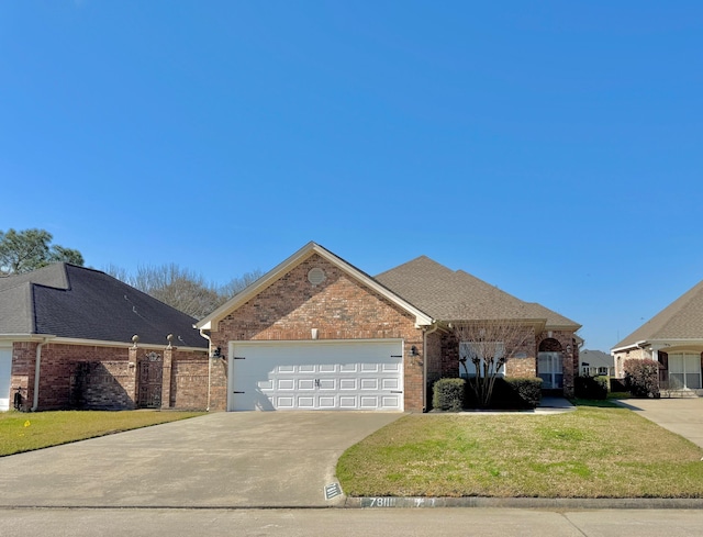 ranch-style house featuring brick siding, roof with shingles, concrete driveway, a front yard, and a garage