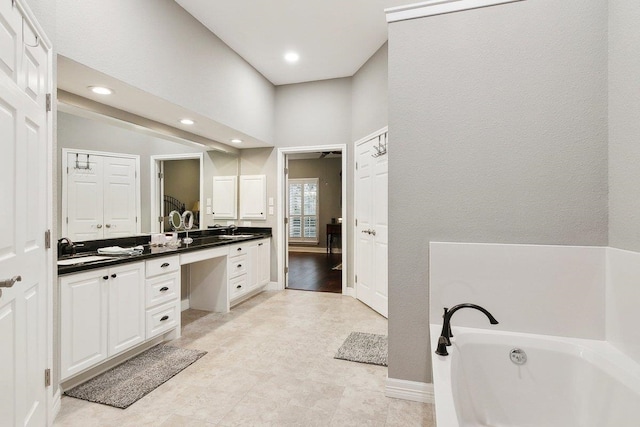 bathroom with vanity and a bathtub