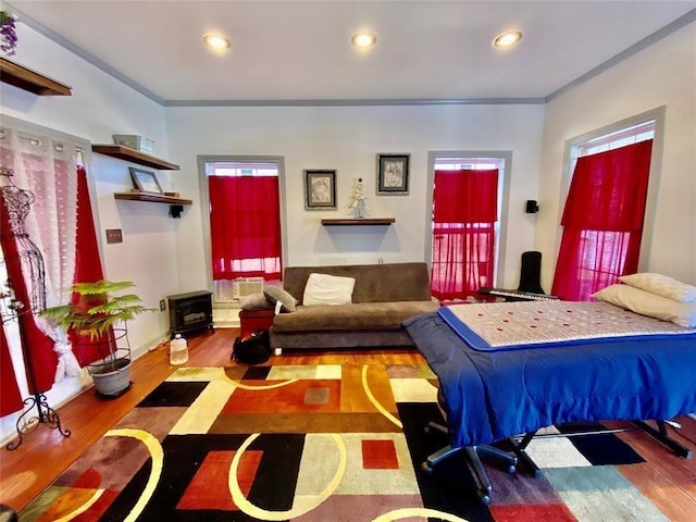 bedroom featuring wood-type flooring and ornamental molding