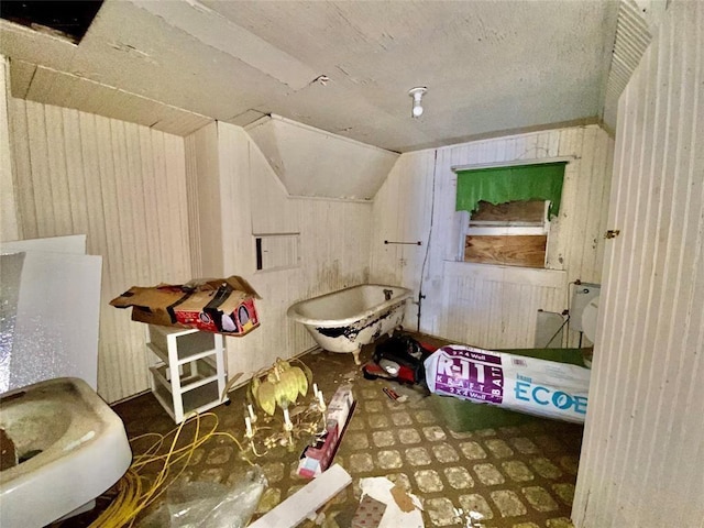 bathroom featuring lofted ceiling