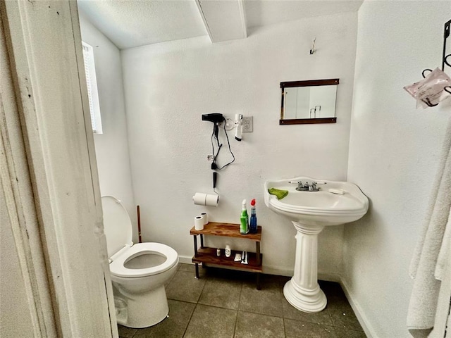 bathroom with tile patterned flooring and toilet