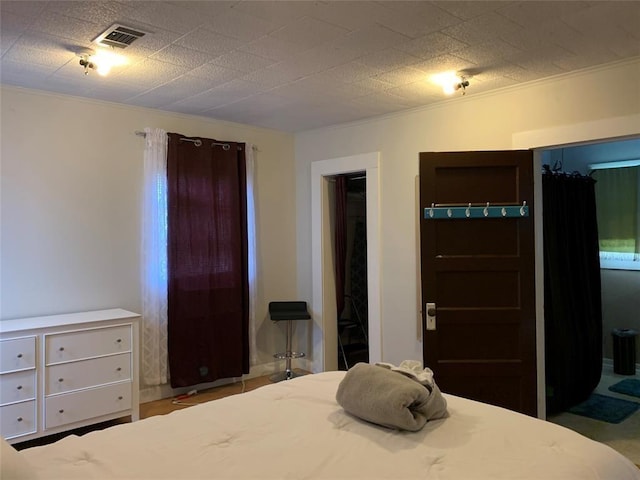 bedroom with a closet and ornamental molding