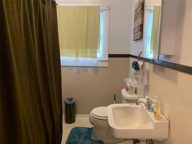 bathroom with tile patterned flooring, toilet, and sink