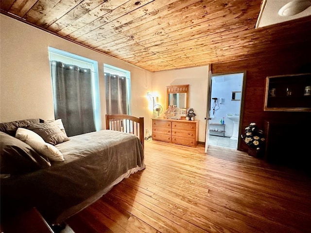 bedroom with ensuite bathroom, wooden ceiling, and light hardwood / wood-style floors