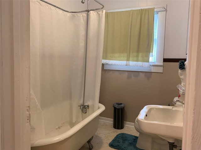 bathroom featuring shower / bath combo and sink