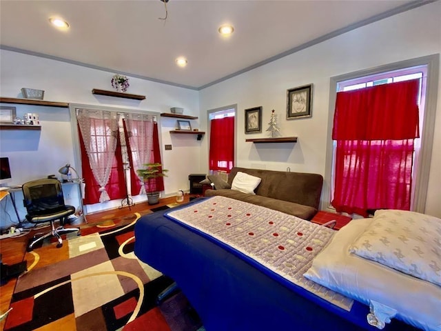 bedroom with crown molding and wood-type flooring