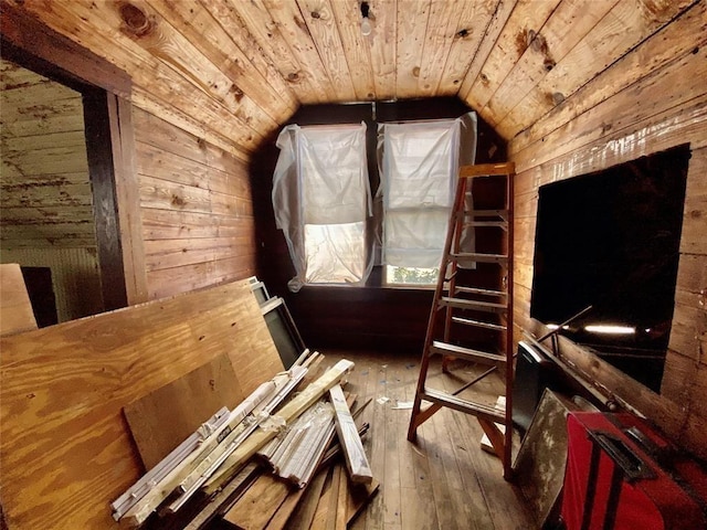 interior space with hardwood / wood-style floors, wood ceiling, wooden walls, and vaulted ceiling