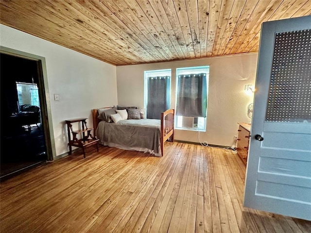 bedroom with wood ceiling and light hardwood / wood-style flooring