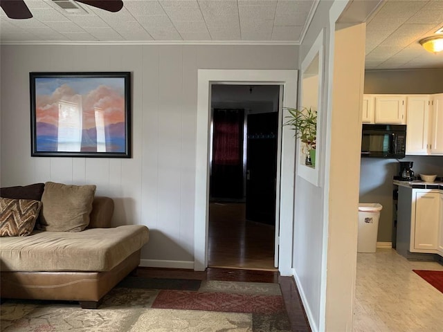 living room featuring ceiling fan and crown molding