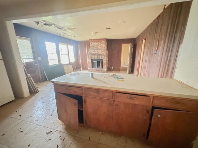 3 Inwood Cir Unit B, Orange, TX 77630 - kitchen with a fireplace, light countertops, and brown cabinetry