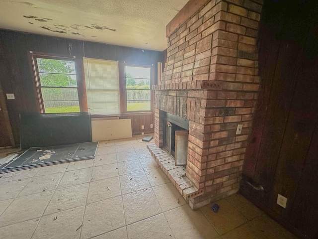 3 Inwood Cir Unit B, Orange, TX 77630 - unfurnished living room featuring plenty of natural light, a brick fireplace, and a textured ceiling