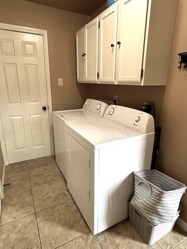 washroom with light tile patterned flooring, cabinets, and independent washer and dryer