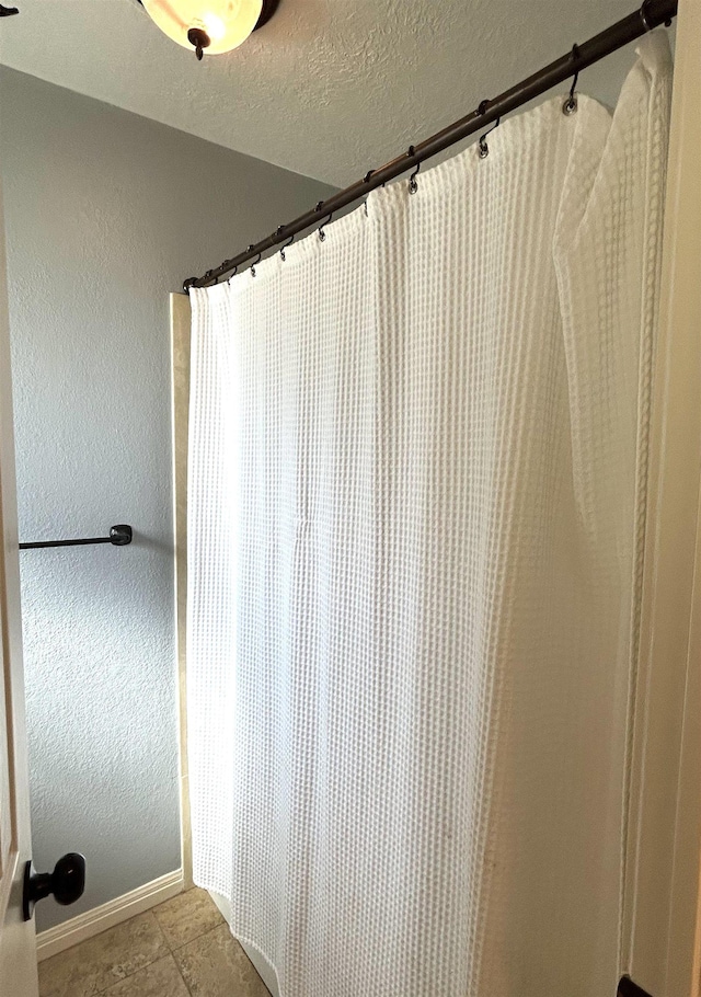 bathroom featuring tile patterned floors and curtained shower