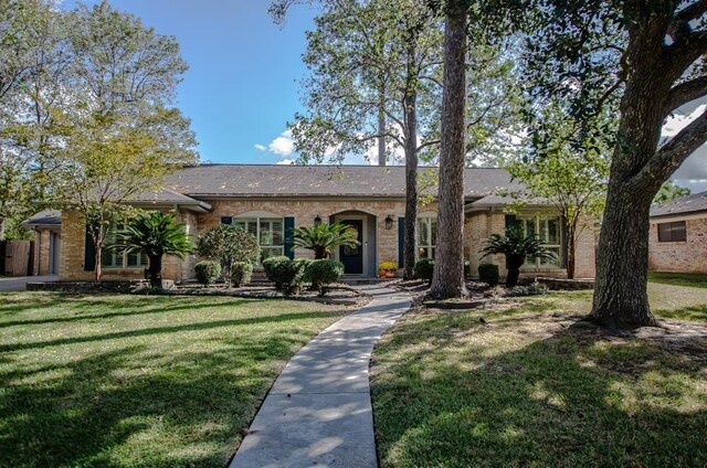 ranch-style house with a front lawn