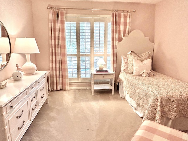 bedroom featuring light carpet and multiple windows