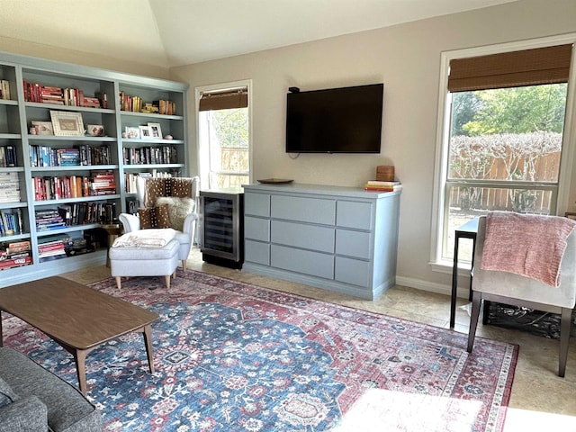 sitting room featuring lofted ceiling and beverage cooler