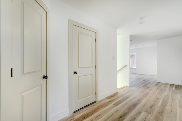 hallway with light hardwood / wood-style flooring