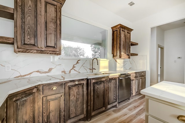 kitchen with dark brown cabinetry, sink, light hardwood / wood-style flooring, stainless steel dishwasher, and decorative backsplash