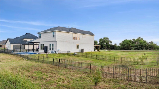 rear view of property with a rural view, a yard, and central AC