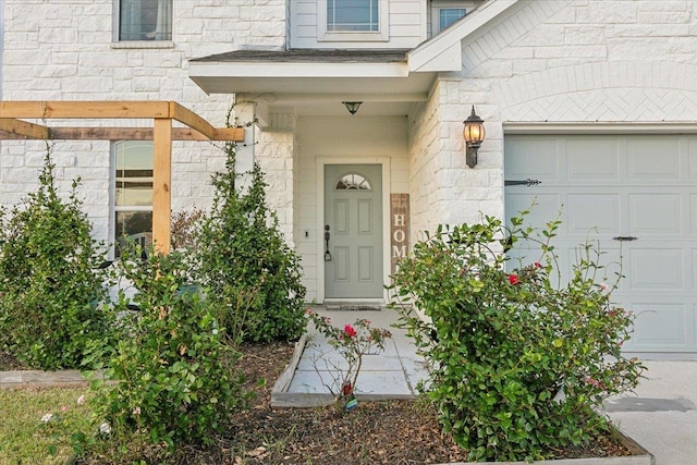 view of exterior entry with a garage