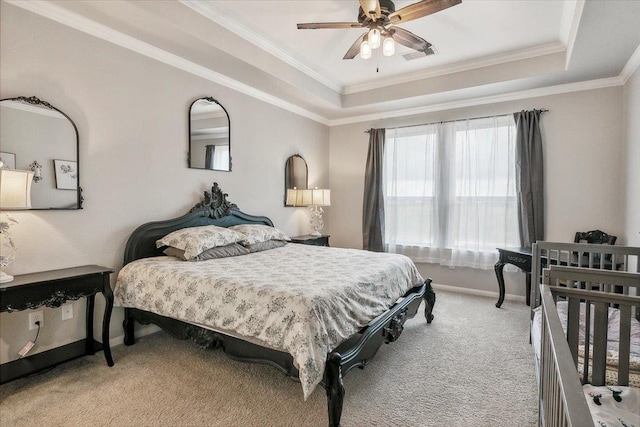 bedroom with a raised ceiling, ceiling fan, light colored carpet, and ornamental molding