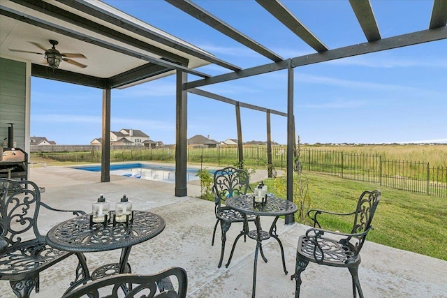 view of patio / terrace with a fenced in pool and ceiling fan