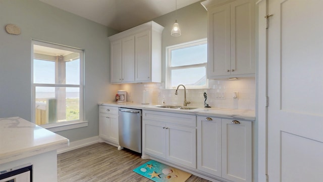 335 Atkinson, Crystal Beach, TX 77650 - kitchen with stainless steel dishwasher, a sink, tasteful backsplash, and light countertops